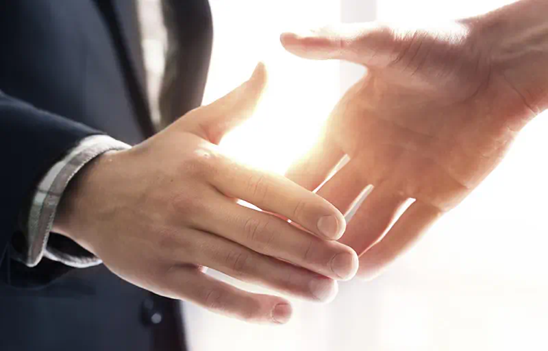 Investment & Disposition Strategy Two business people shaking hands.
